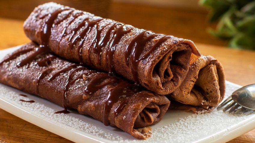 I made this for pancake day or Shrove Tuesday, but why wait all year to eat pancakes! I love pancakes and I could eat them all year round. These are crepes made with chocolate and filled with a creamy coconut filling. Serve them hot with hot chocolate sauce.